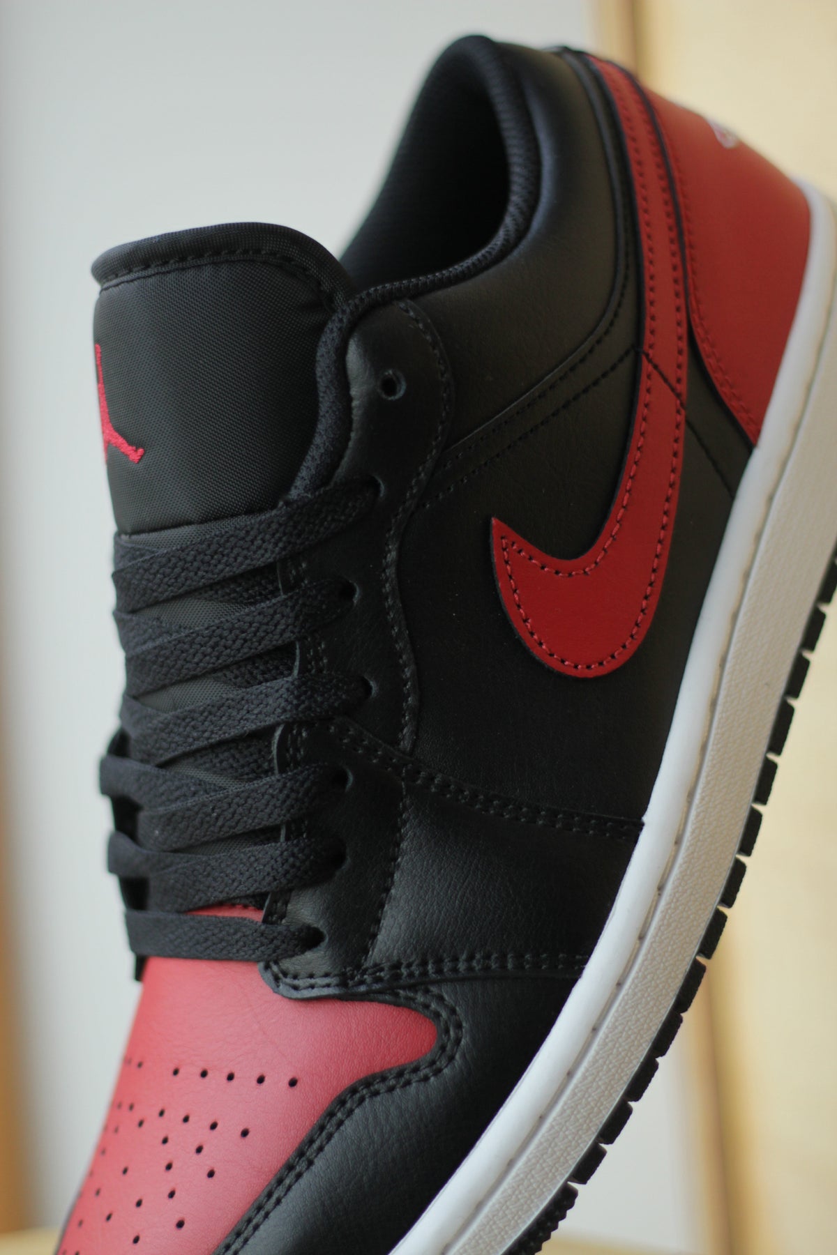 red and black low top jordans